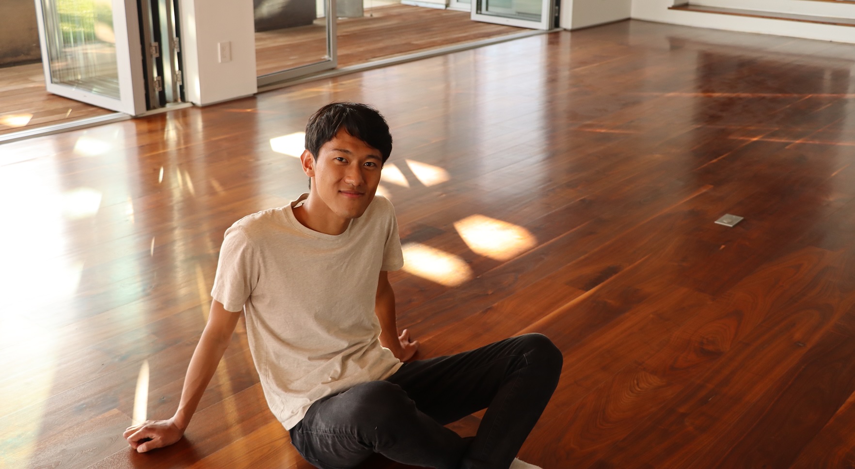 Jimmy sitting on wooden floor